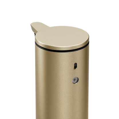 High-angle close-up of Simplehuman 9 oz. Sensor Pump in Brass, showing dosage dial and power switch.
