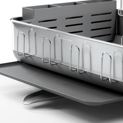 Close-up of Simplehuman Brushed Stainless Steel Steel Frame Dishrack showing integrated cup holders and slotted utensil caddy.